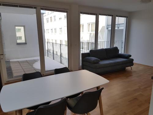 a room with a table and chairs and a couch at 4 Beds and More Vienna Apartments - Contactless check-in in Vienna