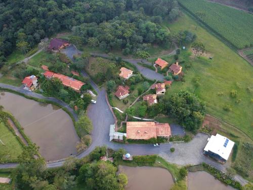 an aerial view of a house with a river at Serra Bela Eco Pousada in Urubici