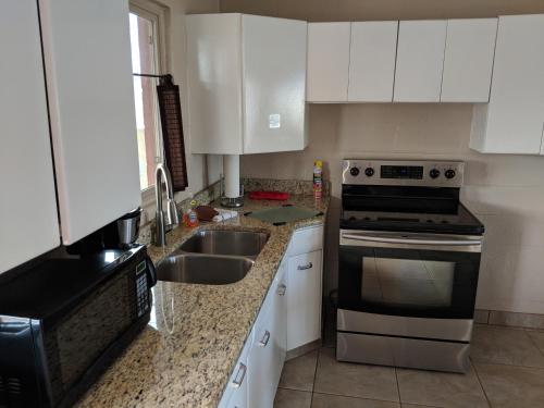 a kitchen with a sink and a stove top oven at Red Rock Motel and Dam Motel in Page