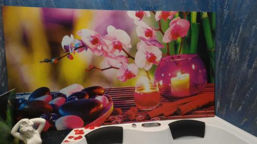 a painting of a vase with flowers and candles on a table at Luxury B&B Coccolhouse in San Cesario di Lecce
