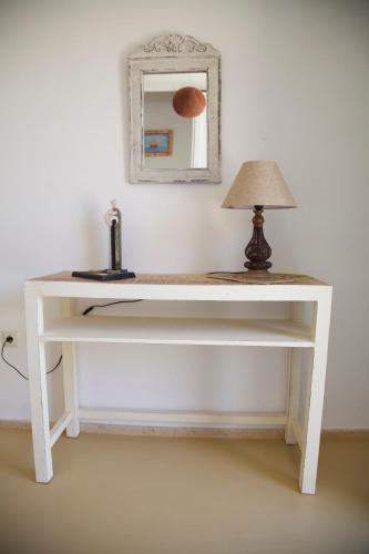 a white desk with a lamp and a mirror at Luxury house in the island of Patmos in Grikos