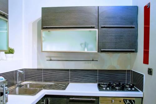 a kitchen with a sink and a stove at yHome | Stylish Chic in Turin