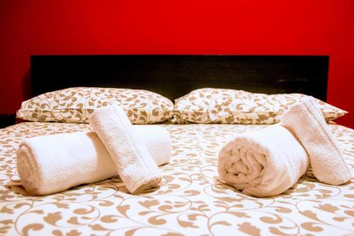 a bed with towels and pillows on it at yHome | Stylish Chic in Turin