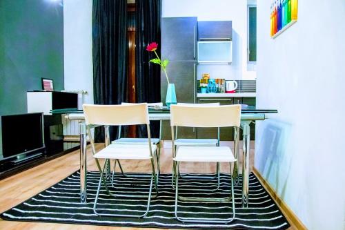 a kitchen with a table and three chairs at yHome | Stylish Chic in Turin