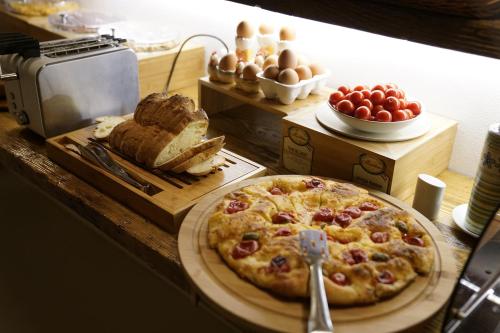 una pizza su un tavolo con pane e uova di Residence Del Casalnuovo a Matera