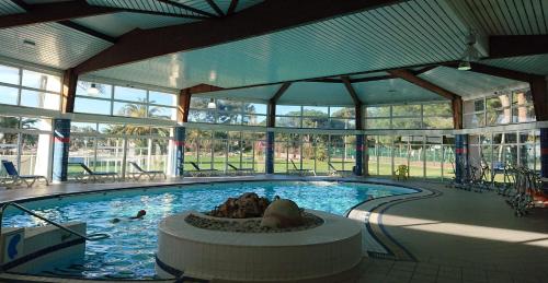 a swimming pool with a person laying in the water at Hotel Club Le Plein Sud Vacances Bleues in Hyères