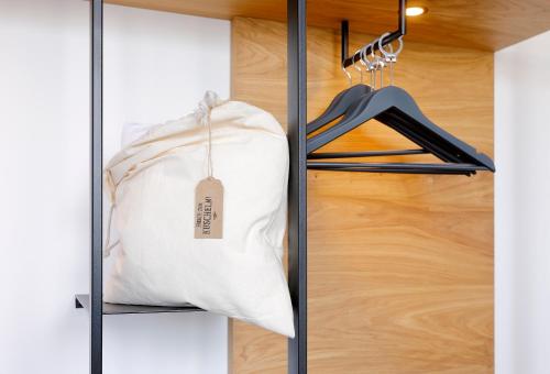 a closet with a white bag on a shelf at Coffee Fellows Hotel Dortmund in Dortmund