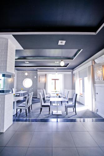 a dining room with white tables and chairs at Hotel Sulbin in Garwolin