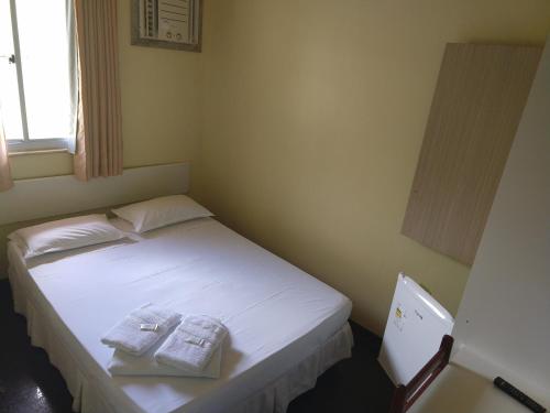 Cuca Legal Hotel tesisinde bir odada yatak veya yataklar