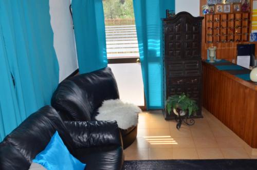 a black leather chair in a room with a window at Residencia Santiago Mallorca in Cala Figuera