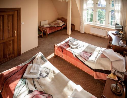 Una cama o camas en una habitación de Hotel Stary Malbork