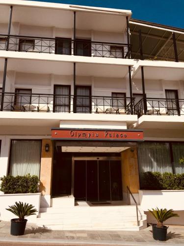 an apartment building with a sign in front of it at Hotel Olympia Palace in Olympia