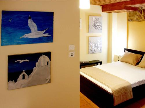 a bedroom with a bed and a painting on the wall at Sweet stone apartment in Imittos in Athens