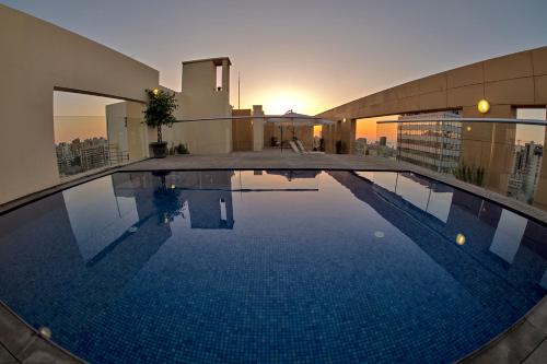 a large swimming pool on top of a building at Kantari Suites in Beirut