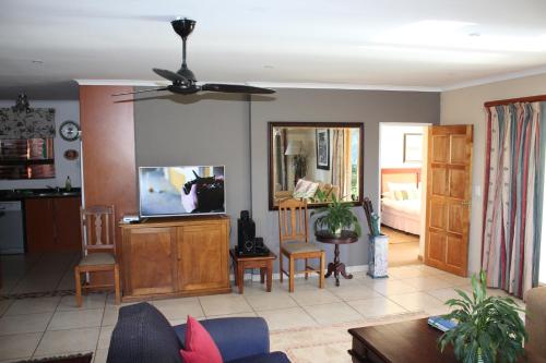 a living room with a couch and a tv at Birdsong Cottage No 9 in Champagne Valley