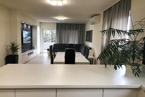 a living room with a couch and a table at Apartments Villa Stivan in Solin