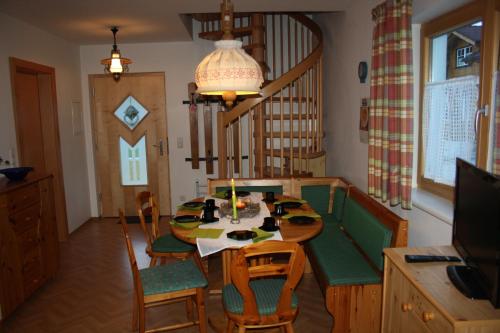 a dining room with a table and chairs in a room at Haus Pfeiffenberger in Eben im Pongau