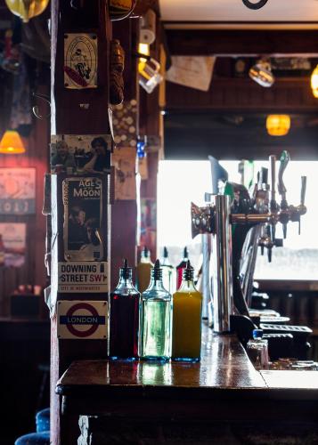 a bar with bottles of alcohol on a table at Maddens Bridge Bar & Guesthouse in Bundoran