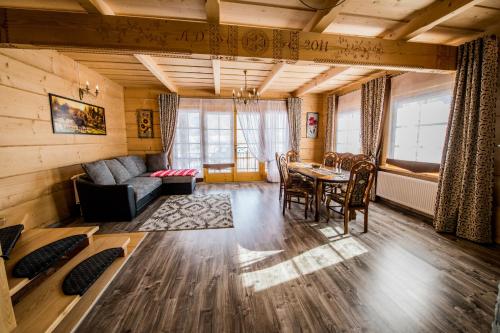 a living room with a table and a couch at Domek Góralski in Poronin