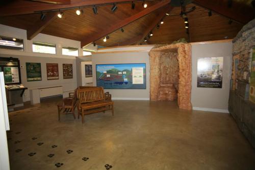 a room with a chair and a table in a museum at Canyon Inn in Spencer