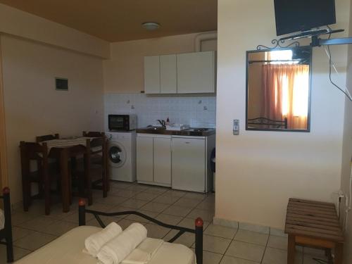 a living room with a kitchen and a table and a kitchen at Belvedere Studios in Kýthira