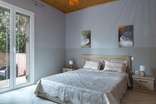 a white bedroom with a bed and a window at Cosy 3bedroom Apartment in Sami