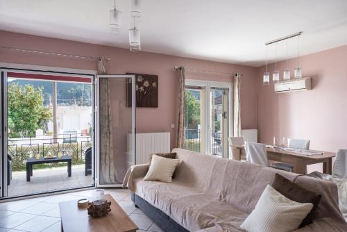 a living room with a couch and a table at Cosy 3bedroom Apartment in Sami