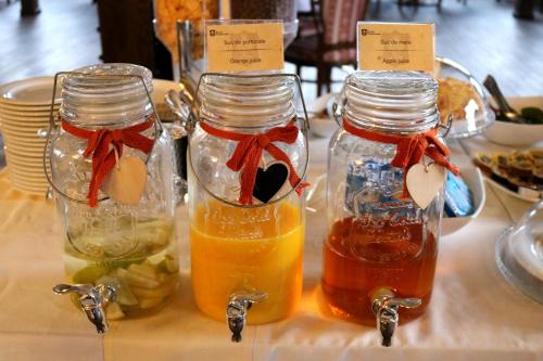two mason jars filled with different types of honey at Castel Transilvania in Baia Mare