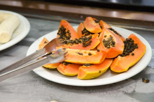 a plate of food with carrots on a table with a fork at Samba Betim in Betim