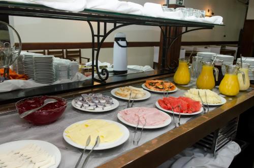 a buffet with plates of food on a table at Samba Betim in Betim
