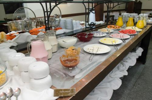 a buffet line with plates and bowls of food at Samba Betim in Betim