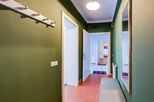 a hallway with green walls and a tile floor at Ferienwohnung Mariazell in Mariazell