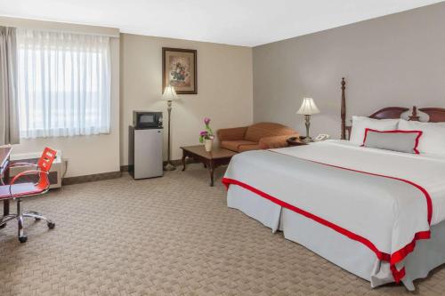 Un pat sau paturi într-o cameră la Ramada Plaza by Wyndham Garden Grove/Anaheim South