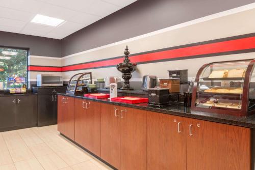 a kitchen with a counter with aasteryasteryasteryasteryasteryasteryasteryasteryastery at Ramada by Wyndham Catlettsburg Ashland in Catlettsburg