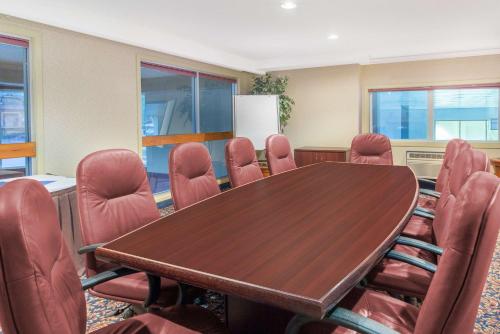 a conference room with a wooden table and chairs at Canmore Inn & Suites in Canmore