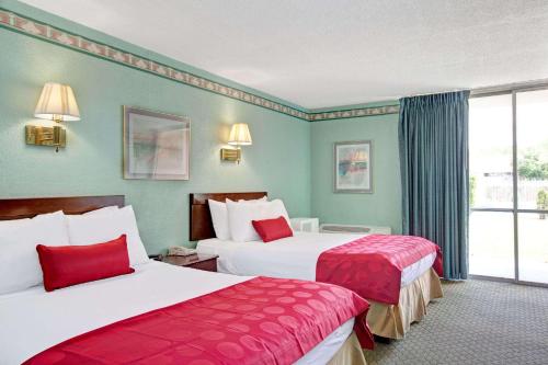 um quarto de hotel com duas camas e uma janela em Ramada by Wyndham Parsippany em Parsippany