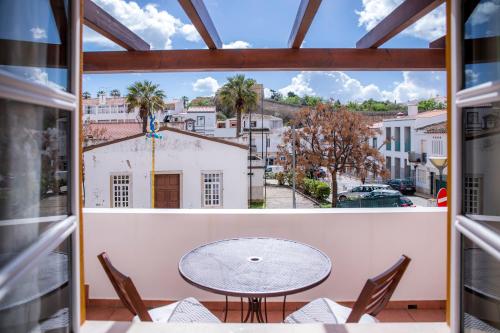 a view from a balcony with a table and chairs at Casinha D'Avó Guesthouse in Lagos