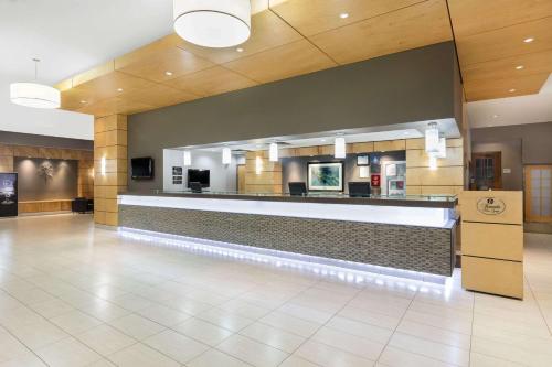 a lobby with a waiting area in a hospital at Ramada Plaza by Wyndham Prince George in Prince George