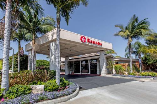 a mobil gas station with palm trees at Ramada by Wyndham Santa Barbara in Santa Barbara