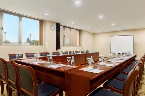 a large conference room with a long table and chairs at Ramada Plaza by Wyndham Gence in Ganja