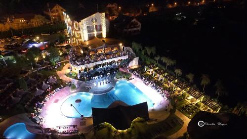 a group of people standing around a pool at night at Castel Transilvania in Baia Mare