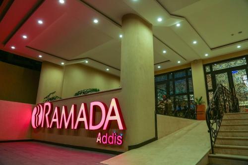 a sign that says rammada addicts in a building at Ramada Addis, Addis Ababa in Addis Ababa