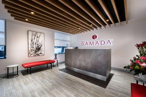 a store with a red bench and a sign on the wall at Ramada by Wyndham VetroBlu Scarborough Beach in Perth