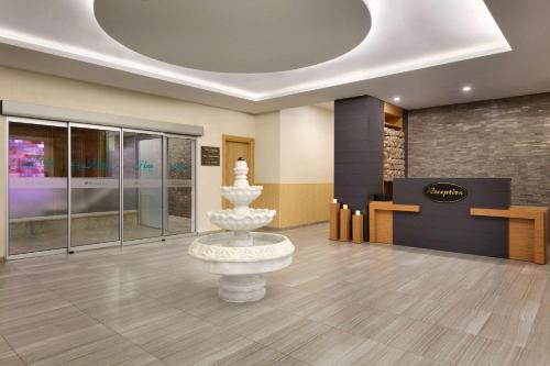 a lobby with a statue in the middle of a room at Ramada By Wyndham Bursa Cekirge Thermal & Spa in Bursa