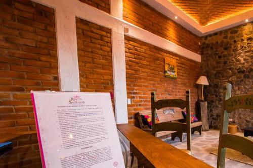 a room with a wooden table with a sign on it at Hotel Boutique Rincon Sagrado in Atlixco