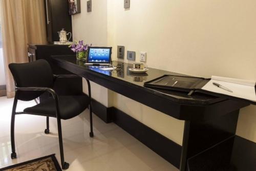 a desk in a hotel room with a laptop on it at Terra Nova, BW Premier Collection in Kingston