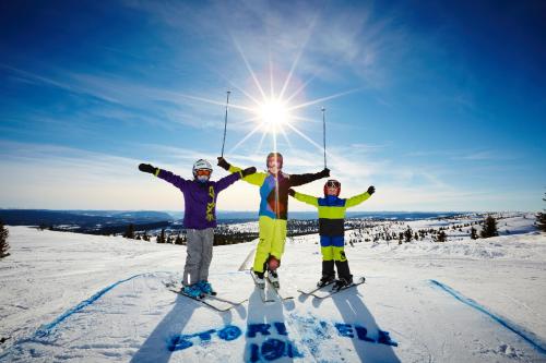 a group of three people standing on top of a ski slope at Storefjell Resort Hotel in Gol