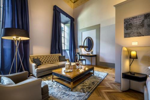 a living room filled with furniture and a fireplace at Palazzo Ridolfi - Residenza d'Epoca in Florence