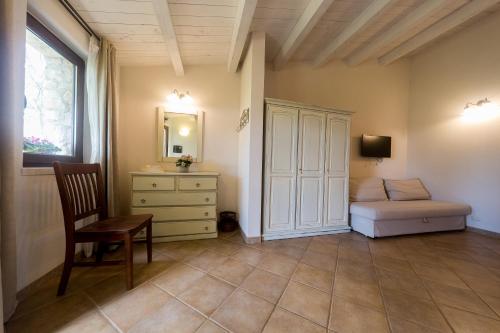 a bedroom with a bed and a cabinet and a chair at Nacalino Agriturismo in Modica