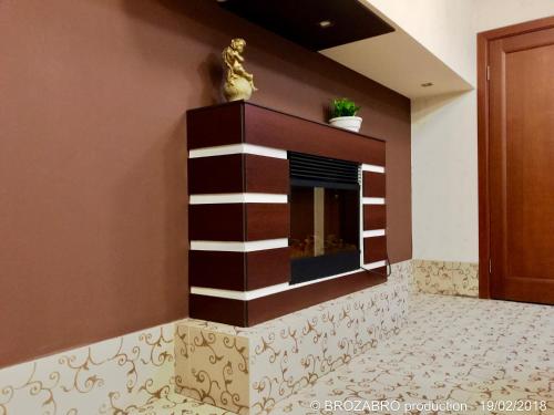 a living room with a fireplace in the corner at Kharkovlux in Kharkiv